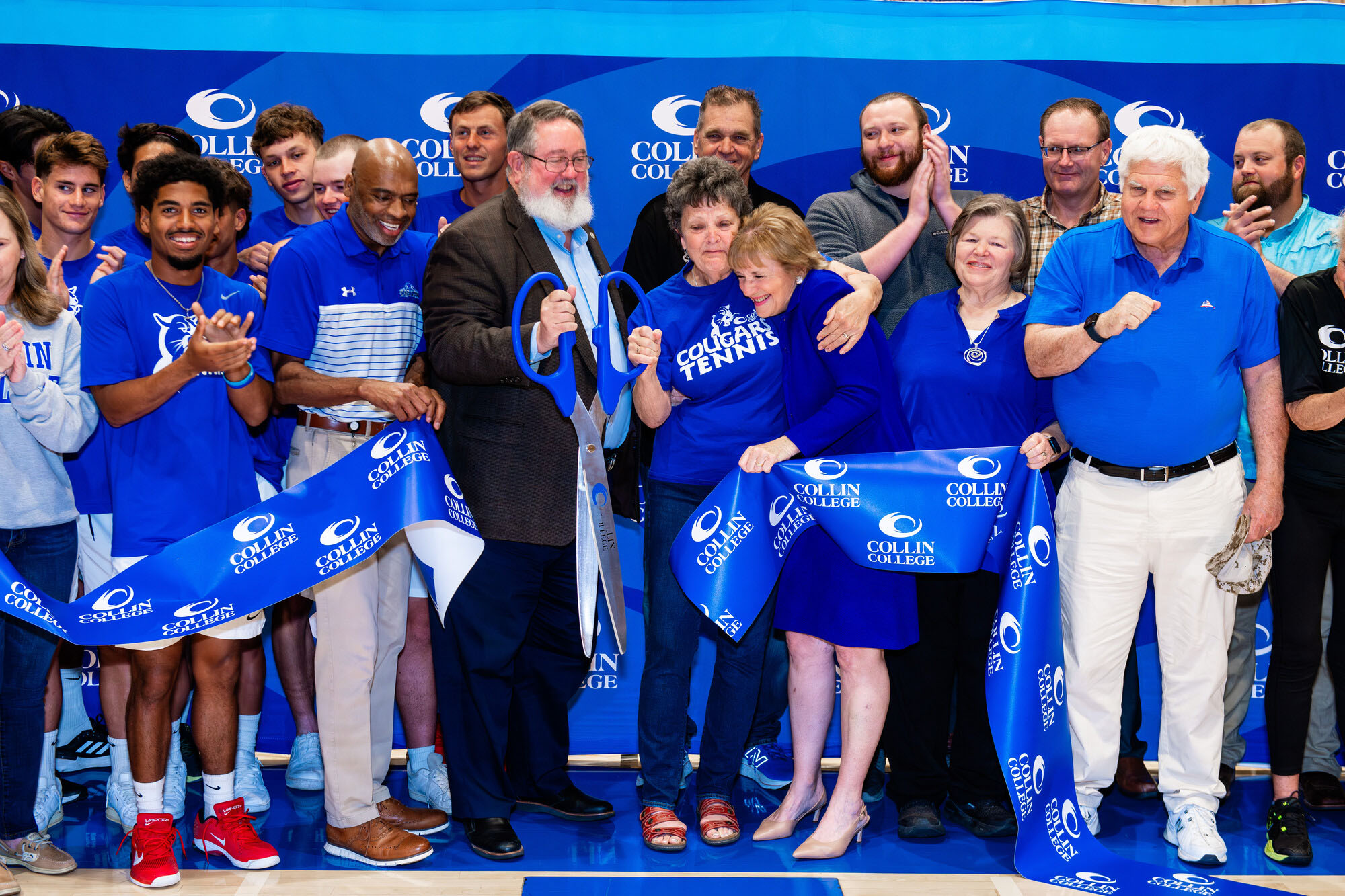 Dr. Neil Matkin, Sharon Berryman, Cindy Brinker Simmons and dozens of well-wishers cut the ceremonial ribbon dedicating the Marty Berryman Tennis Center in Plano, Texas.