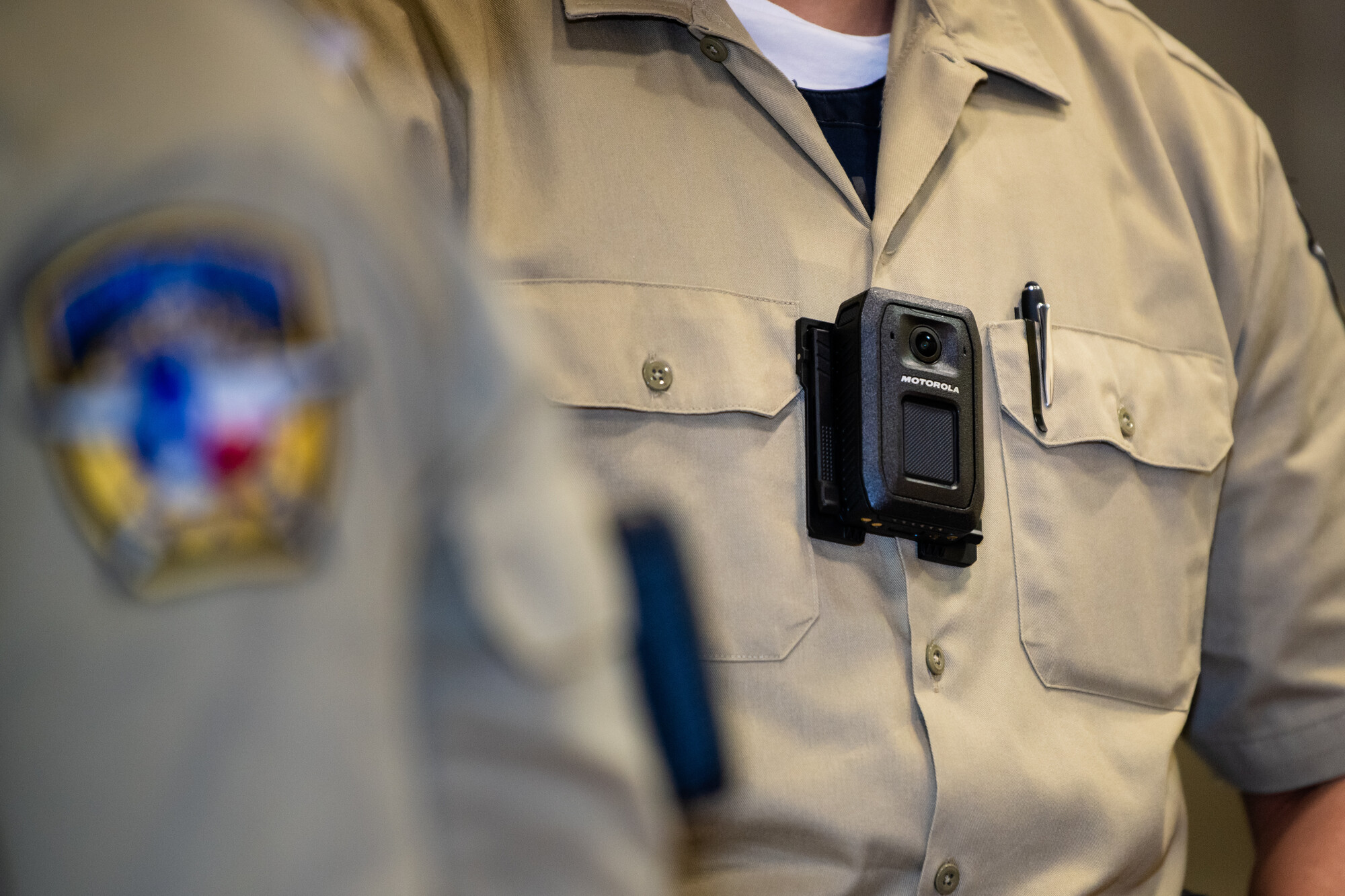 A Motorola V700 body camera is attached to a law enforcement academy cadet's uniform. 