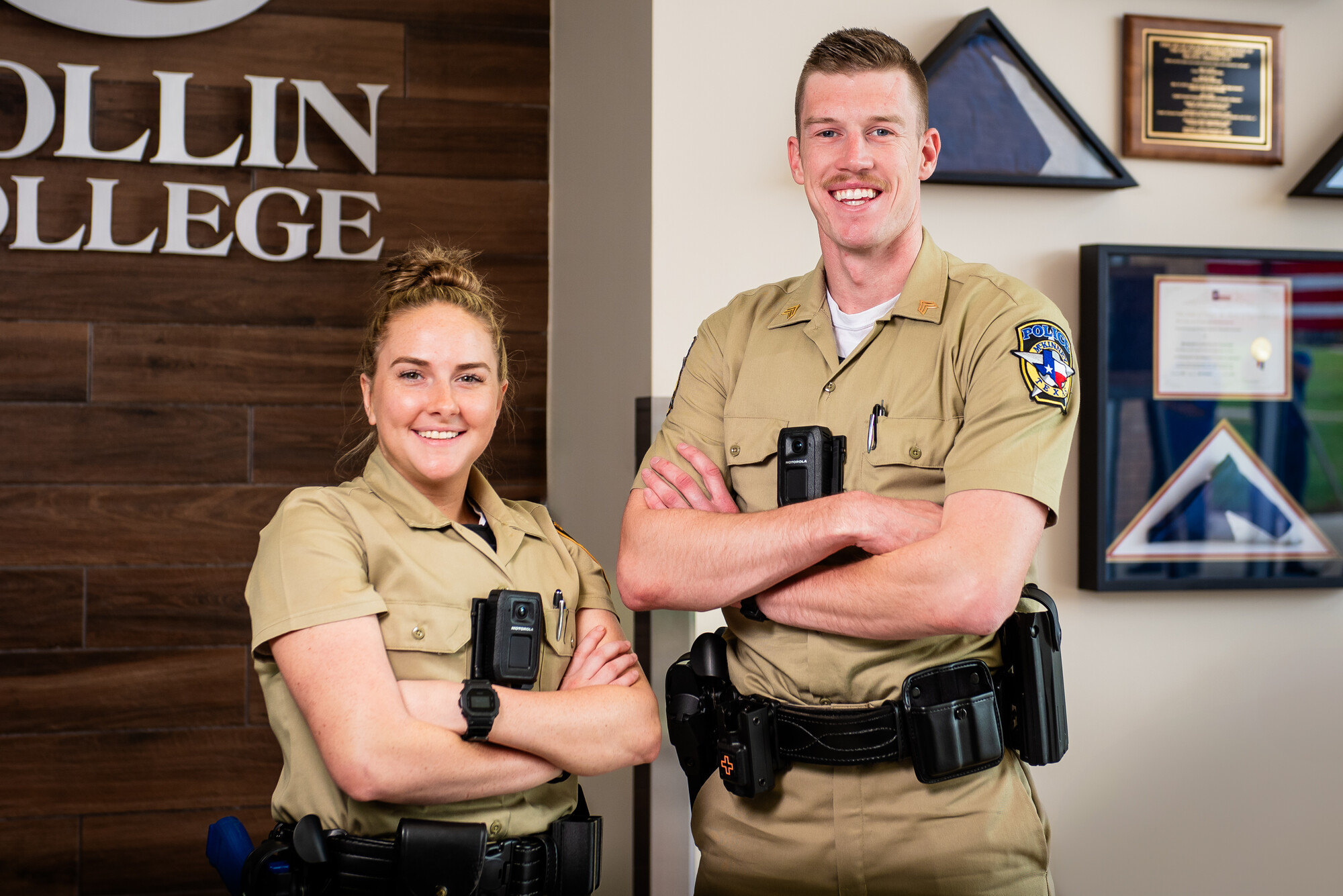 Two law enforcement academy cadets pose with newly donated Motorola V700 body cameras