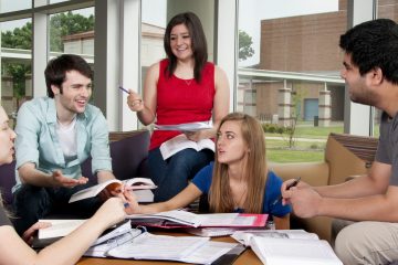 Students studying together on campus in library.