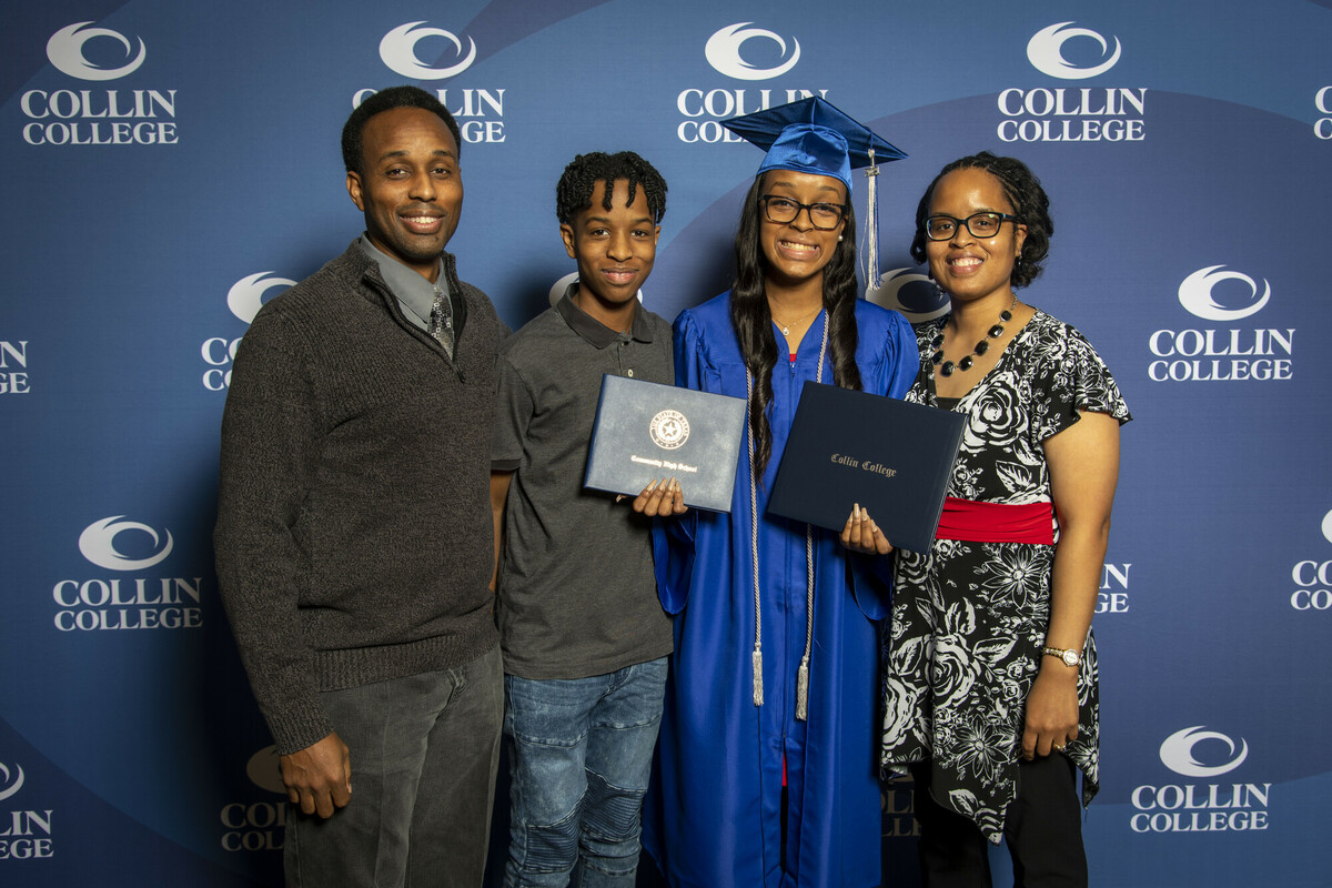 Dominique Hawkins poses with her family at the Collin College 2021 graduation ceremony while holding both her high school diploma and Collin College degree.