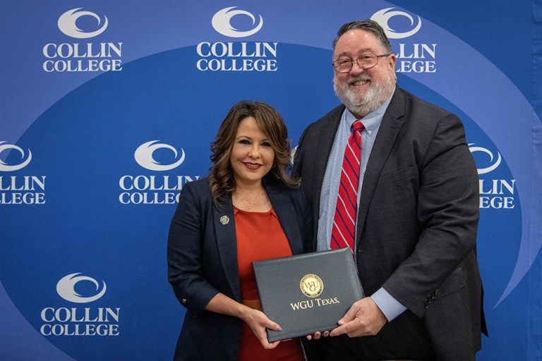 Linda Battles, chancellor of WGU Texas, and Collin College District President Dr. Neil Matkin pose together while holding a WGU Texas diploma.