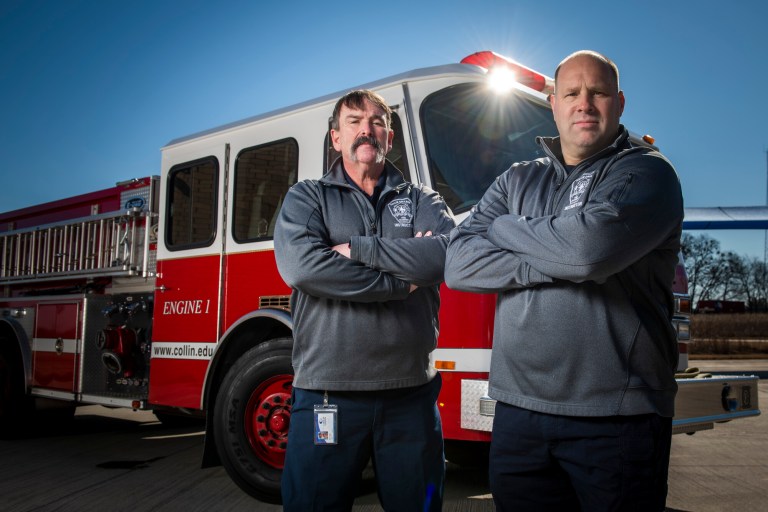 Collin College Fire Science Instructors Stever Cruz and Bret Storck pose in front of a fire engine.