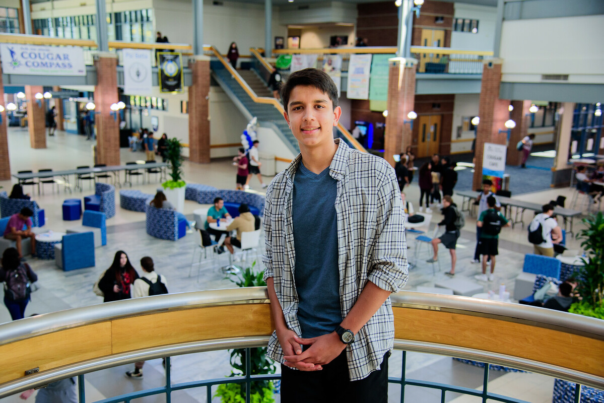Collin College dual credit student Alexander Kader poses on the stairwell inside the Plano Campus atrium.